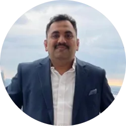 A man with short hair, wearing a blazer
